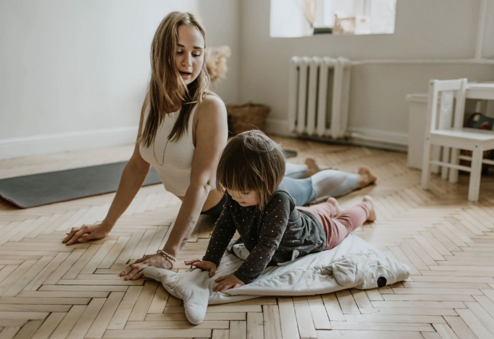 Mother and Daughter Doing Yoga inside house